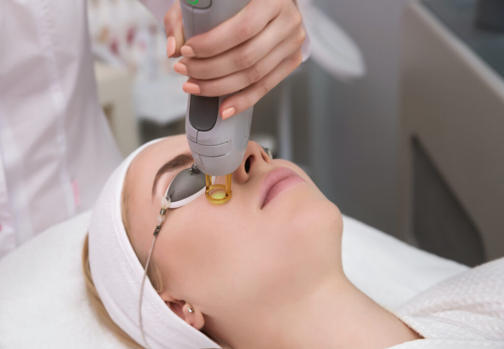 Dermatologist using a laser device for skin treatment